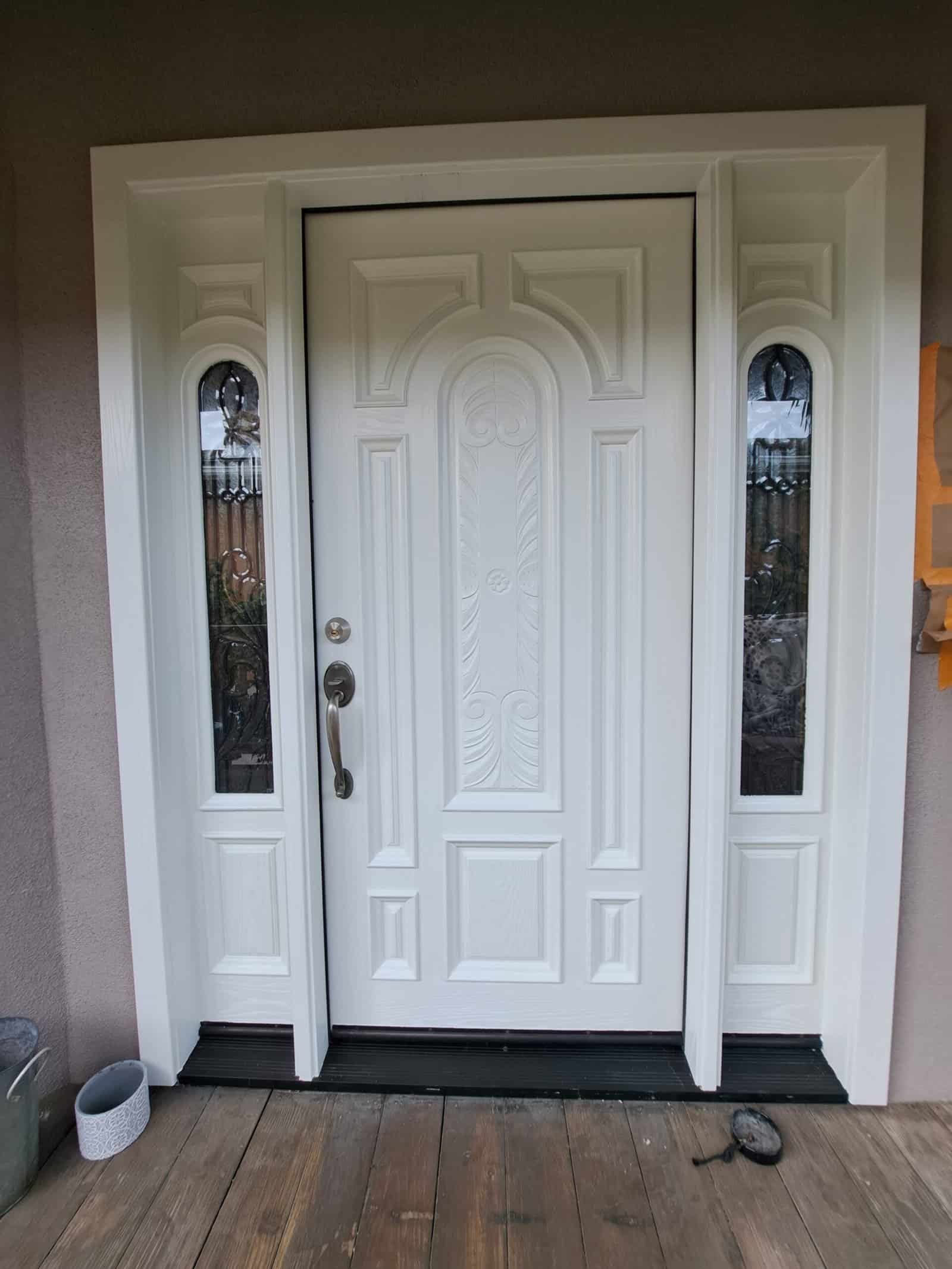 Hand-painted front door with detailed moldings and decorative glass panels for curb appeal.