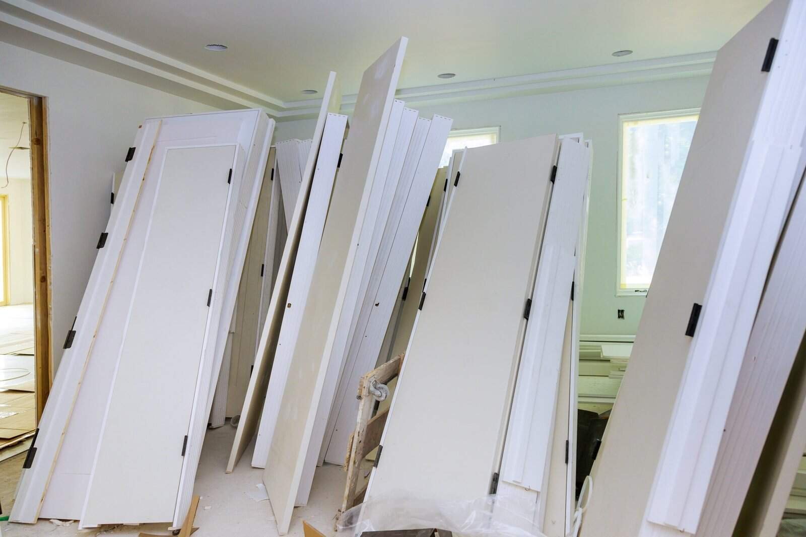 Huge collection of white interior doors in a home renovation project.